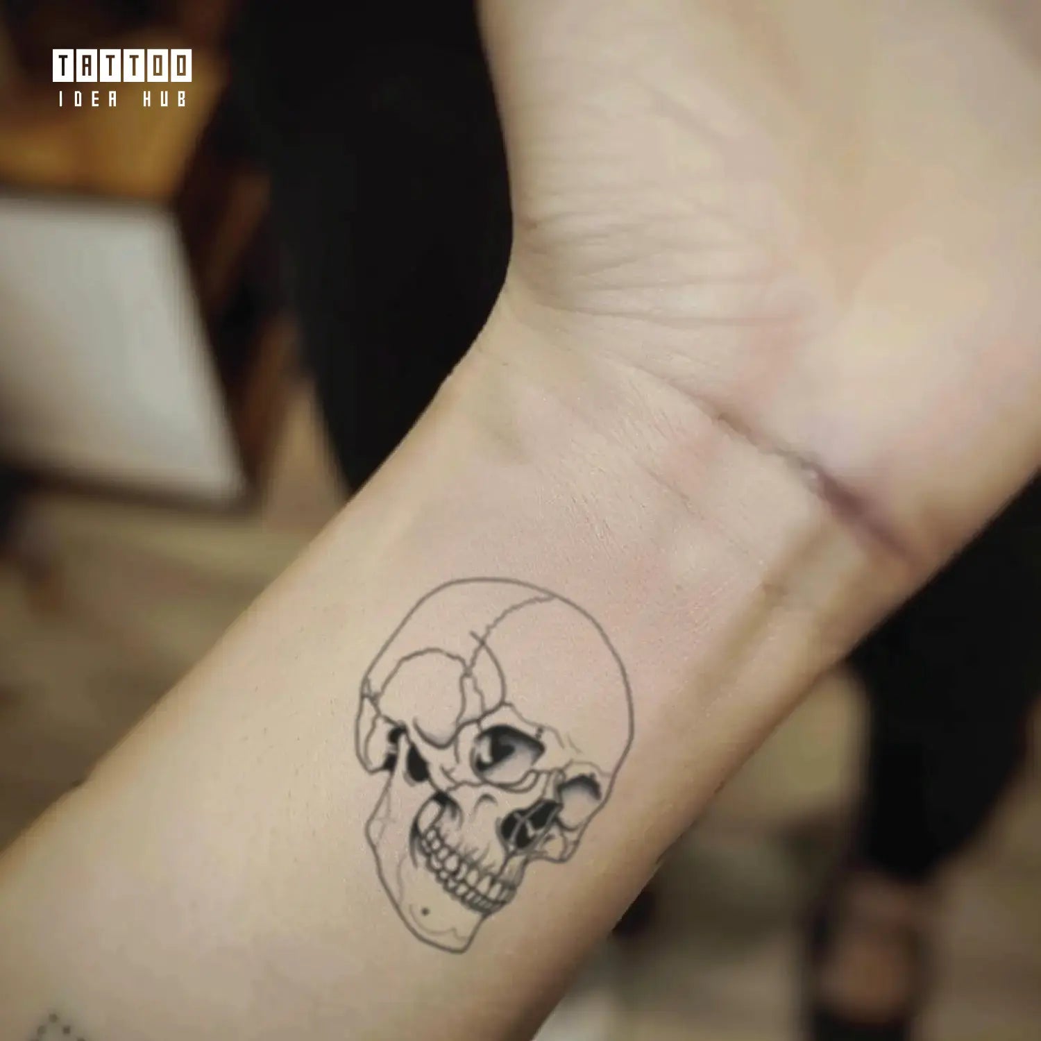 simple skull outline wrist temporary tattoo idea design