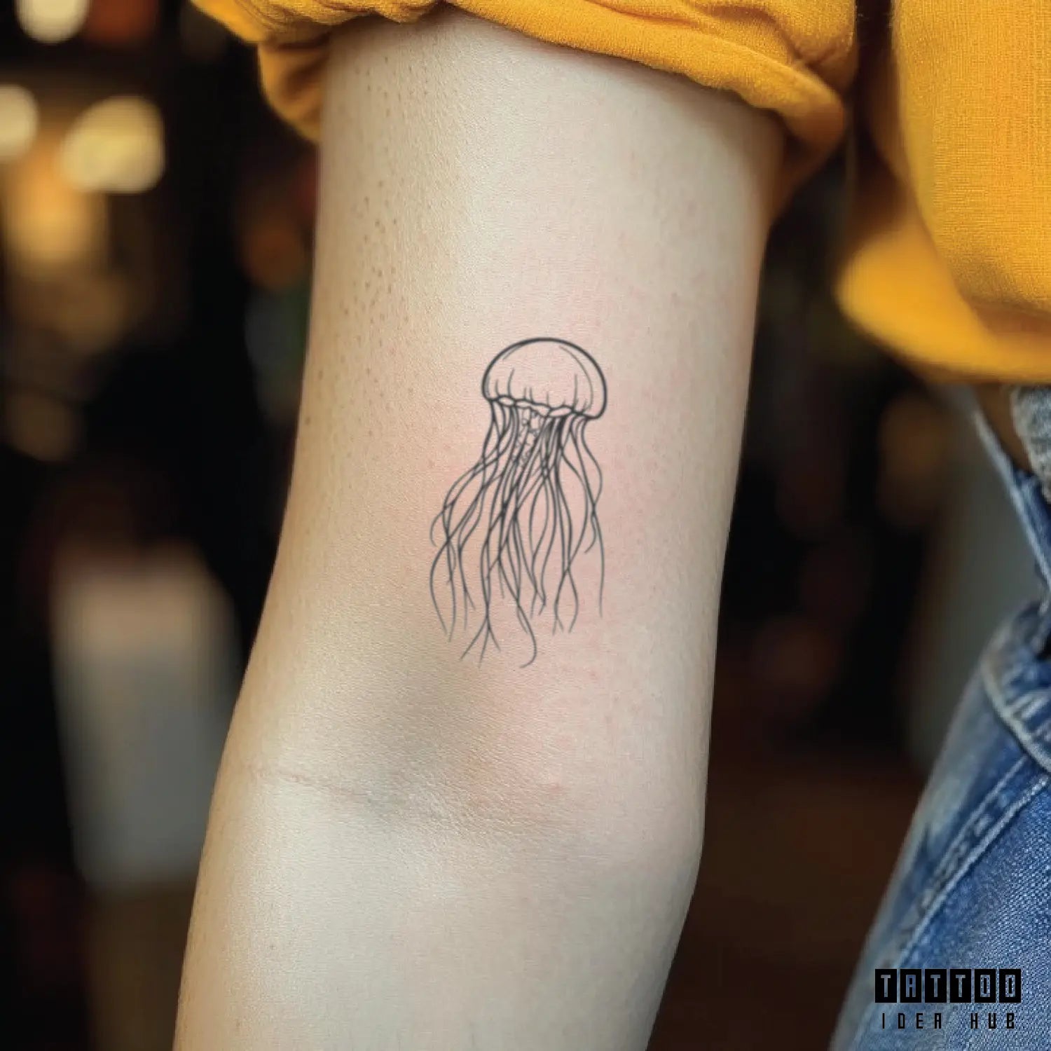 fine line jellyfish bicep temporary tattoo idea design